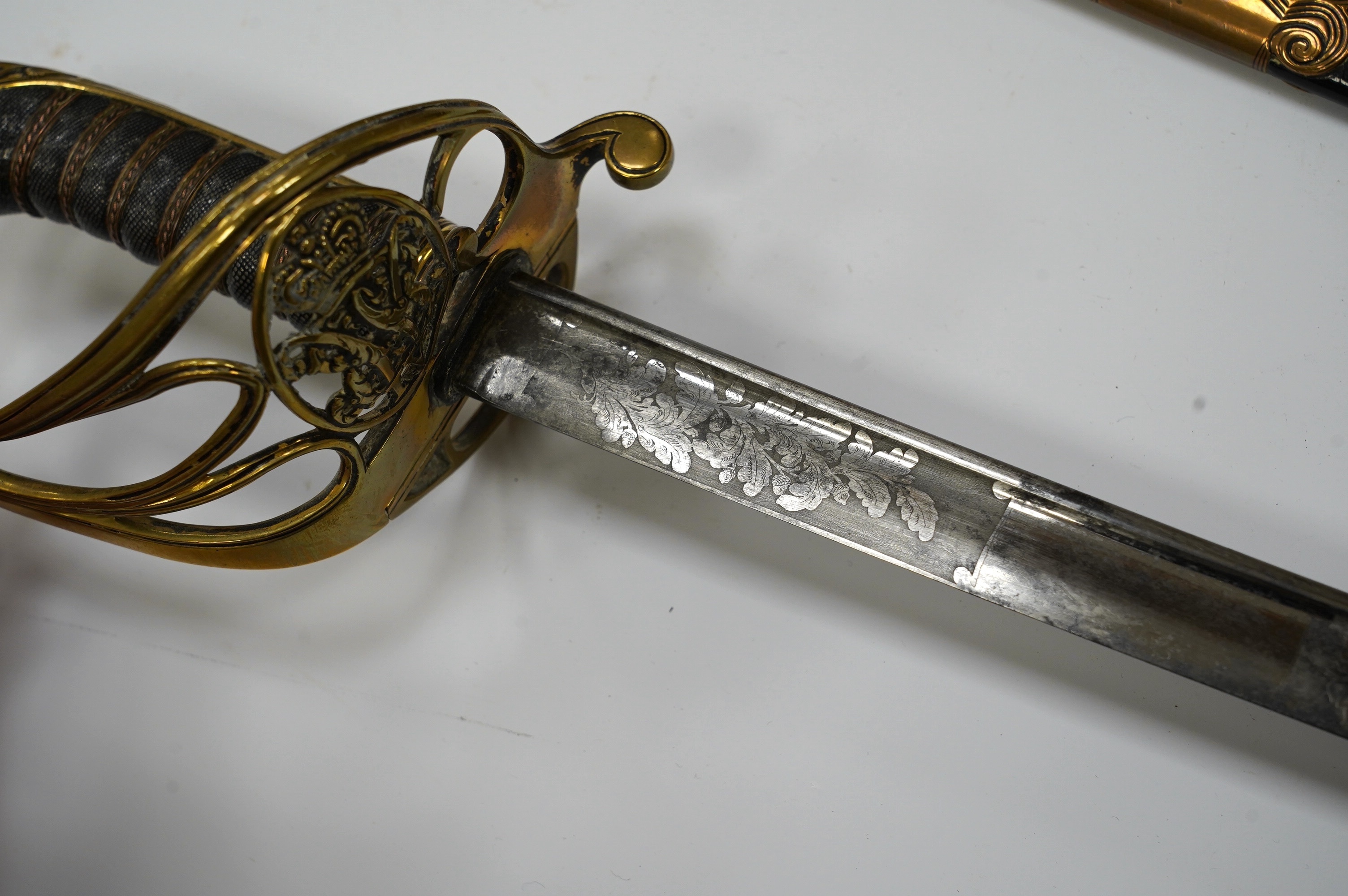 An early 19th century officer's sword, William IV cypher to knuckle guard, folding knuckle guard, engraved curved blade with William IV cypher and makers signature; ‘Vernon 4 Charing Cross London’, leather scabbard with
